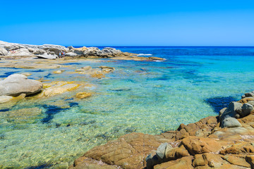 Fototapeta na wymiar Crystal clear sea water on coast of Sardinia island, Italy