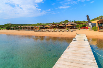 A wooden pier on Santa Manza beach, Corsica island, France