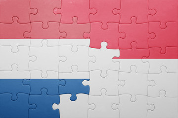 puzzle with the national flag of indonesia and netherlands