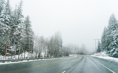 Empty road with snow covered landscape in winter season.