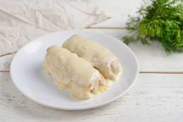 Fototapeta na wymiar stuffed cabbage with white sauce and dill