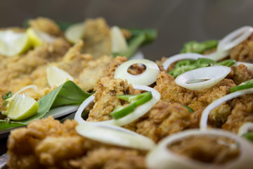 fried fish with onion and pepper, selective focus on central.