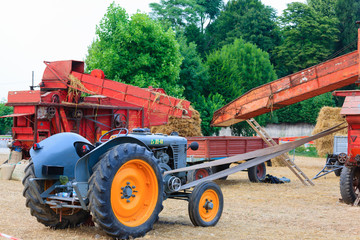 Perspective view of and old tractor and a straw baler, agriculture, rural life