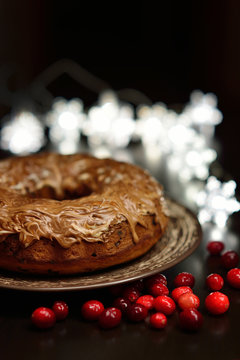 chocolate cake with cranberries on a dark background with Christ