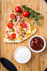 Piece of pizza with ham and tomatoes