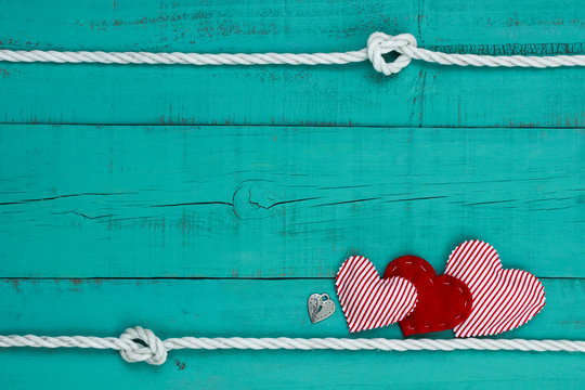 Blank rustic sign with rope border and red hearts