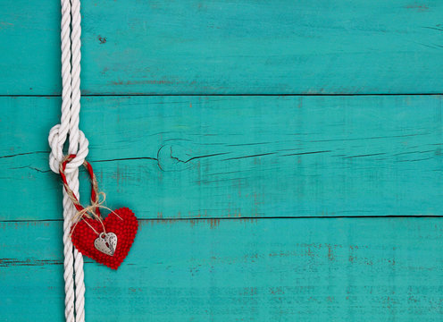 Blank teal blue sign with rope border and red heart