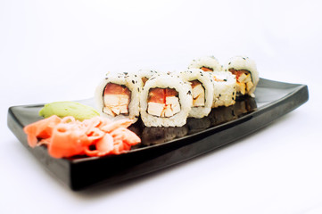sushi roll platted on a black plate