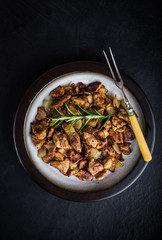 Beef stew with frest rosemary in plate on black table