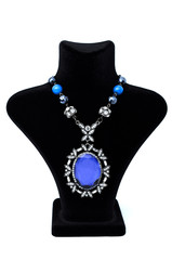 Pendant with big blue stone on a mannequin isolated on white