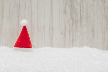 Red Santa hat in the snow