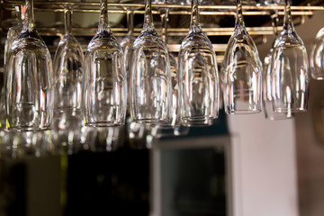 different types of glass hung up on bar