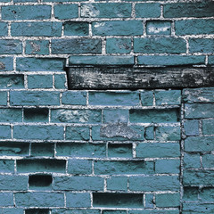 Blue brick wall background texture, with wooden plinth.