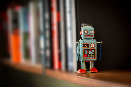 Vintage tin toy robot on a book shelf