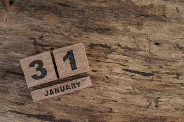 wooden cube calendar for january on wooden surface with copy space
