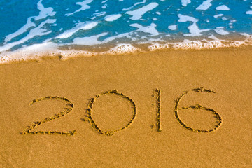 Happy New Year 2016 on the sea beach.