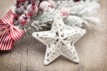 Christmas decoration with fir branches on the wood background.