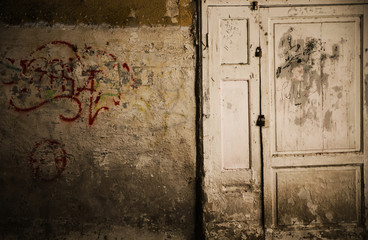 old rusty door with a graffiti