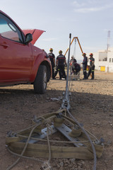 firefighter working with a mechanical tensioning steel cable