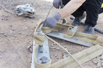 firefighter working with a mechanical tensioning steel cable