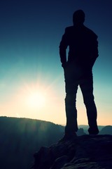 Silhouette of Young Confident and Powerful Man Standing with Hands on Hips, Morning Or Late Day Sun with Copy Space