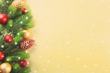 Christmas fir tree branches with toys on paper background