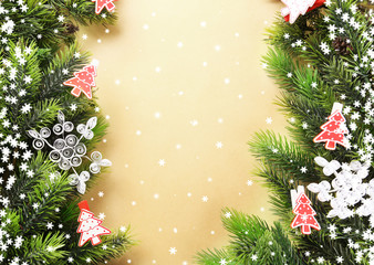 Christmas fir tree branches with toys on paper background
