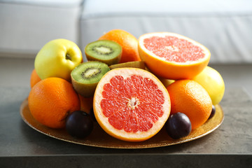 Fresh fruits on table in living room, close up