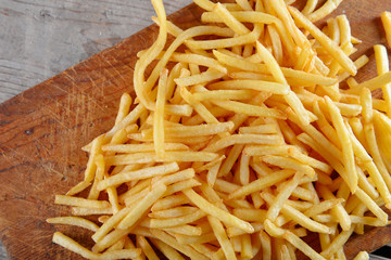 French fried potatoes on cutting board