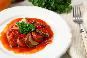 Ratatouille on plate, on table background