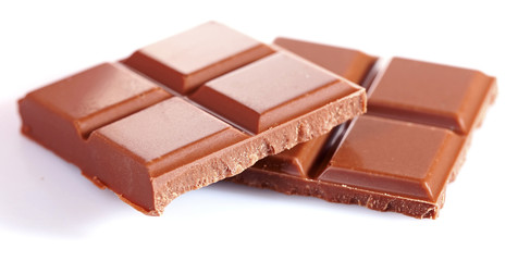 Milk chocolate pieces isolated on white background