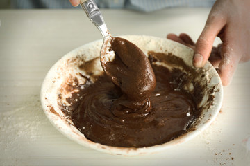 Woman is mixing dough for a chocolate pie