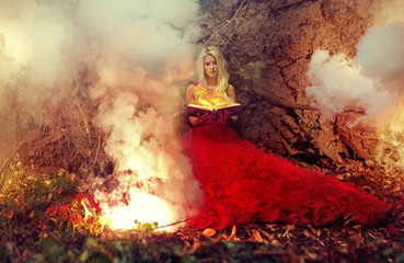 Blond nymph holding firing magic book