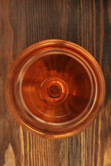 Fototapeta premium Glass of wine on wooden table. Top view