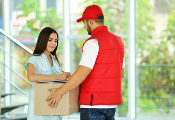 Young woman and courier - delivery concept
