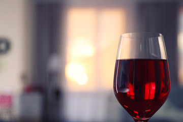 Glass of red wine on blurred background