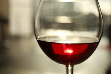 Glass of red wine on blurred background