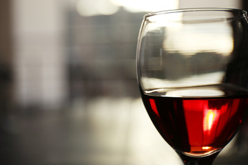 Glass of red wine on blurred background
