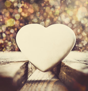 Valentine’s Day Composition. White Heart on Beautiful Background. Toned image in retro style.