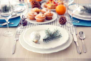 White plates with flatware on a Christmas table