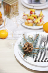 White plates with flatware on a Christmas table