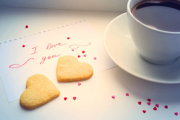 Cup of coffee, cookies in the shape of a heart and a declaration