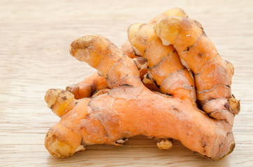 Fresh turmeric on wooden.
