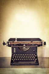 Vintage Typewriter on Old Desk with Grunge Background