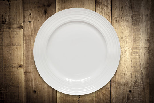 Empty White Plate over Rustic Timber