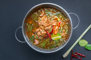 Spicy Thai style beef soup on black background - 98535610