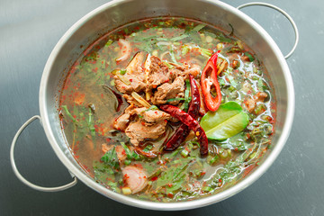 Spicy Thai style beef soup on black background