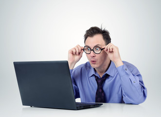 Programmer in glasses with laptop