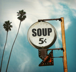 aged and worn vintage photo of soup sign with palm trees