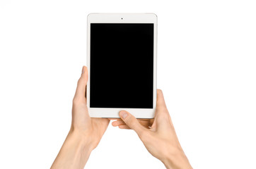 Presentation and advertising touchscreen topic: human hand holding a white tablet touch computer gadget with touch blank black screen isolated on a white background in the studio, first-person view - 98538217